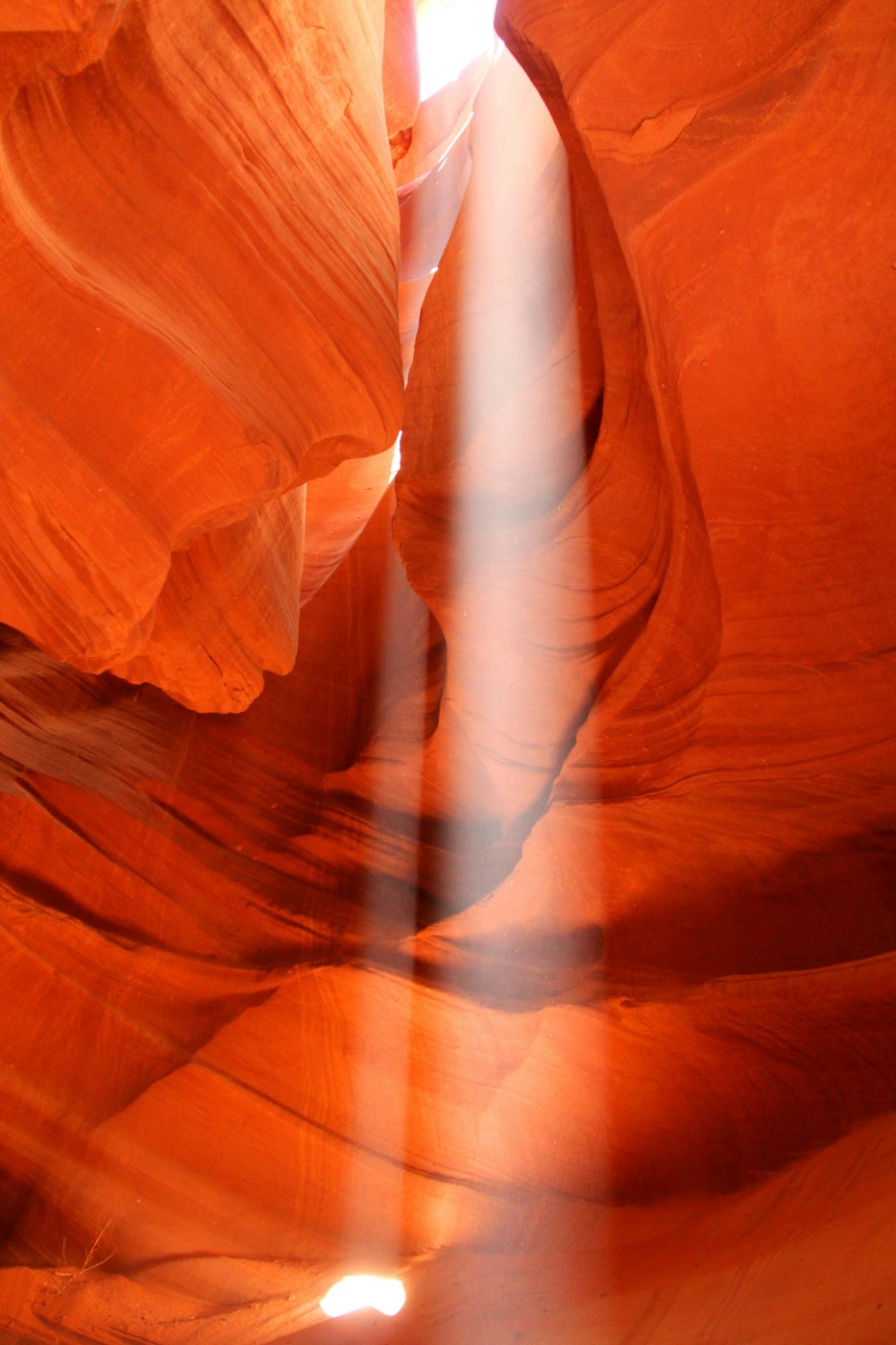 A shaft of light falling through a sandstone canyon